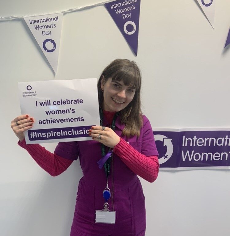 A woman holding a sign