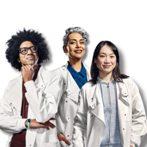 Image of several scientists in lab coats standing side by side